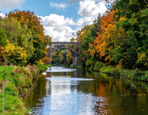 Autumnal bridge over a calm river