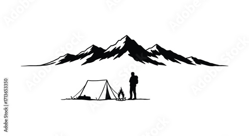 Silhouette of a camper gazing at majestic mountains and campfire glow