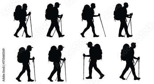 Silhouettes of hikers with backpacks and trekking poles in motion