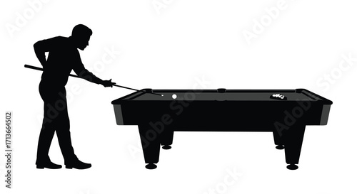 Silhouette of a man taking a shot on a pool table