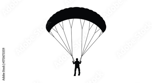 A silhouetted view of a paraglider descending from the sky above