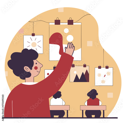 Young man hanging his drawing on wall in art classroom with students  