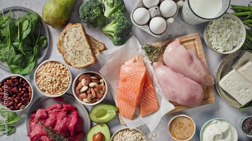 flat lay composition of various fresh protein diet products on grey background, top view. healthy eating, various fresh healthy products on grey table, top view. Healthy food clean eating selection