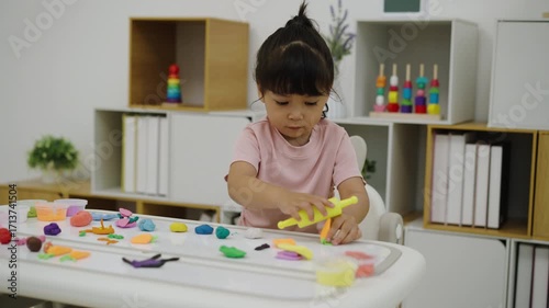 toddler girl with sculpting from plasticine at home