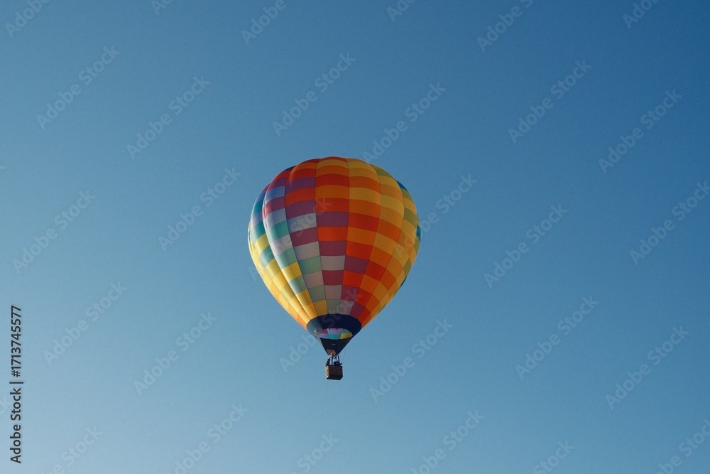 Obraz premium Colorful hot air balloon soaring in a clear blue sky