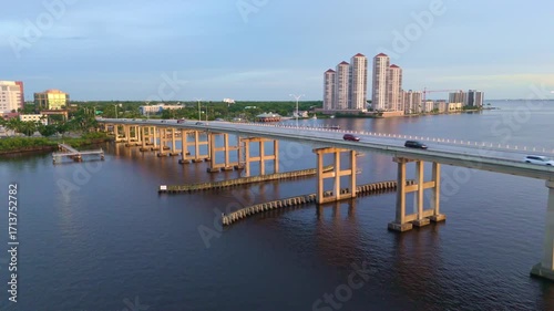 Wallpaper Mural Caloosahatchee Bridge over river at dusk, Fort Myers cityscape in background, Florida, USA. Aerial drone at low altitude Torontodigital.ca