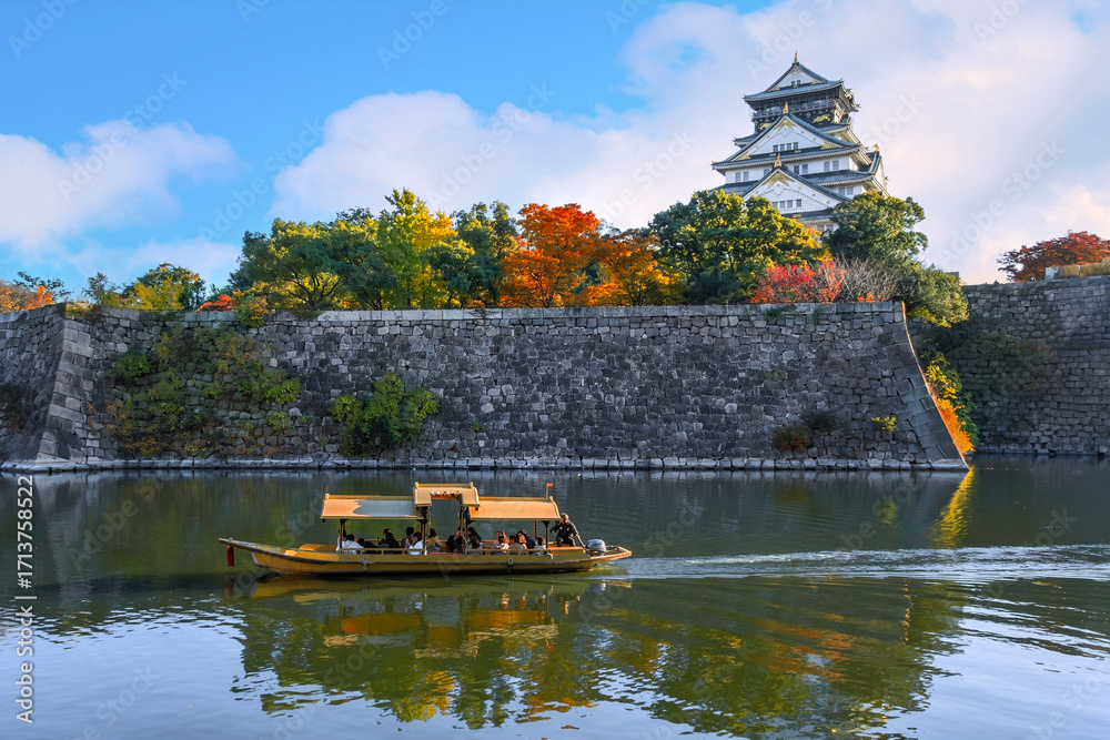 Obraz premium Osaka Gozabune boat ride with tourists at the inner moat of Osaka castle in Osaka, japan