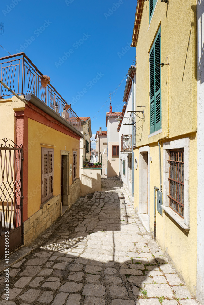 Obraz premium A street among the old houses of Pescopagano, a small medieval town in the province of Potenza, Italy.