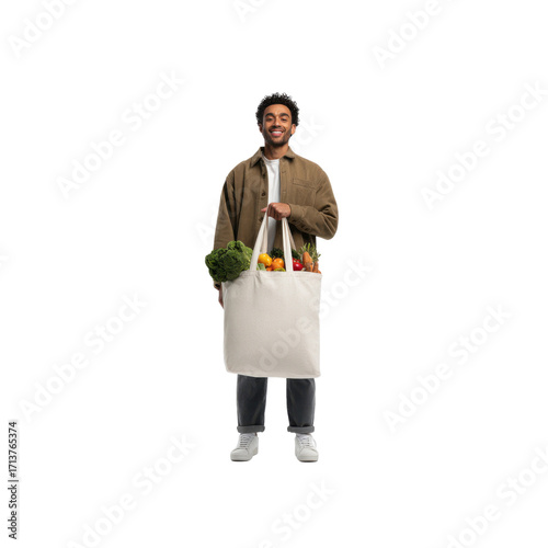 Happy Young Man Carrying Reusable Shopping Bag Filled with Fresh Produce