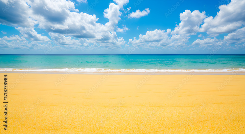 Obraz premium Golden Sandy Beach Meets Turquoise Ocean Under Sunny Cloudy Skies