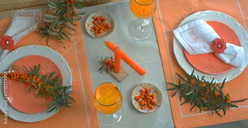 Sea buckthorn branches and sea buckthorn juice on the table