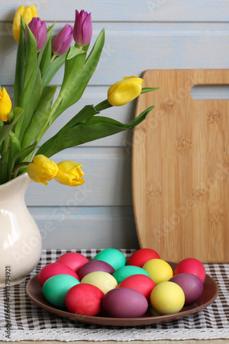 Easter eggs and colorful tulips celebrating spring holiday