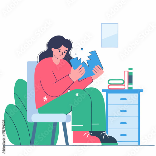 Girl sitting on chair looking at torn notebook in cozy room  