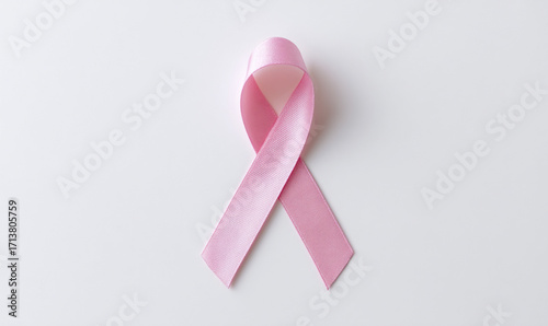 A Hopeful Pink Ribbon Symbolizing Breast Cancer Awareness Placed on a Clean White Background Highlighting the Importance of Early Detection and Support. generative ai