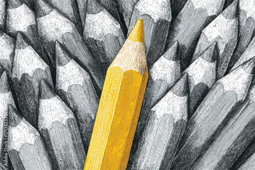 One yellow pencil standing out from crowd of black and white pencils showcasing uniqueness concept