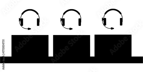 Three headsets with microphones over three computer monitors in a clean, modern workspace