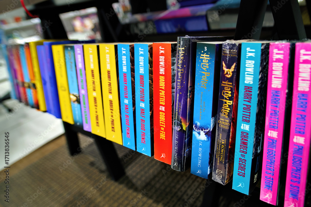 Fototapeta premium Minsk, Belarus. Jan 12, 2025. English editions of Harry Potter novels written by J.K. Rowling arranged on bookshelf inside bookstore, literature display for fans of fantasy adventures. Selective focus