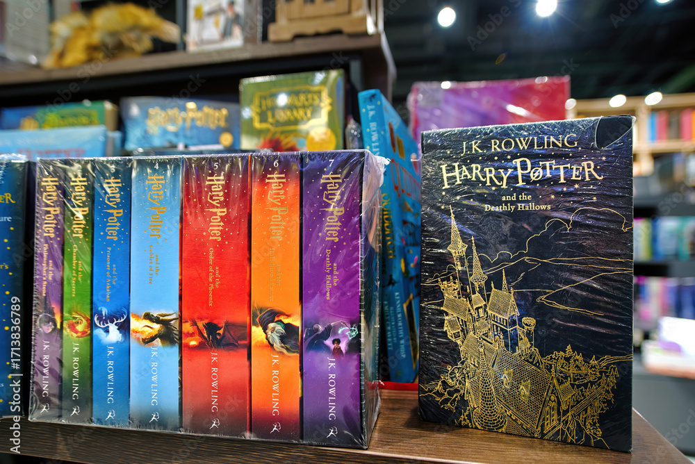 Naklejka premium Minsk, Belarus. Jan 12, 2025. Bookstore shelf with arranged Harry Potter novels in english editions written by J.K. Rowling, fantasy literature collection, magical adventure series. Selective focus