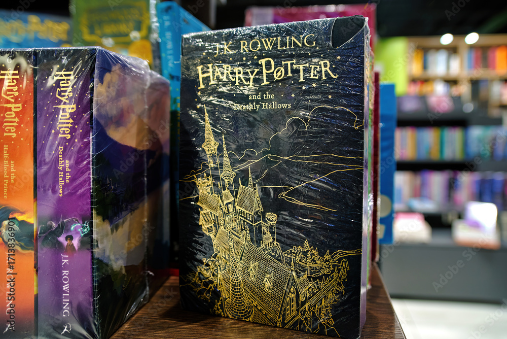 Naklejka premium Minsk, Belarus. Jan 12, 2025. English editions of Harry Potter and Deathly Hallows novel written by J.K. Rowling on bookshelf, literature display for fans of fantasy adventures. Selective focus