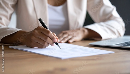 A Close-Up of an African American Businesswoman's Hand Signing a Contract with a Pen, Symbolizing a Finalized Business Agreement