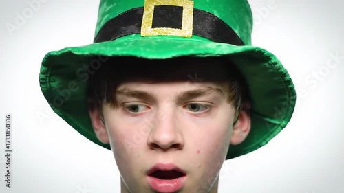 Surprised teen in a green leprechaun hat
