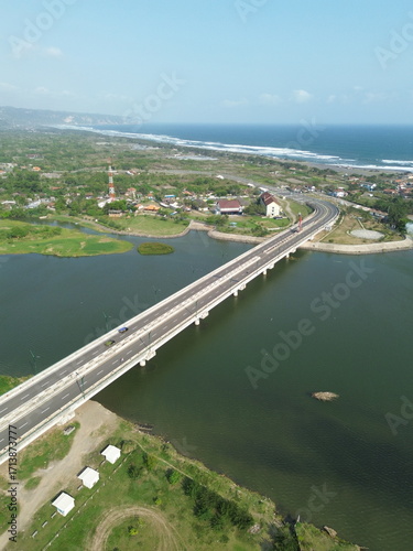 Wallpaper Mural Special Region of Yogyakarta, Indonesia - September 3, 2025 : A Scenic Bridge Spanning a Wide River with Lush Green Surroundings Torontodigital.ca