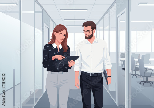 Dynamic business professionals collaborating in a modern office hallway, discussing data on a tablet