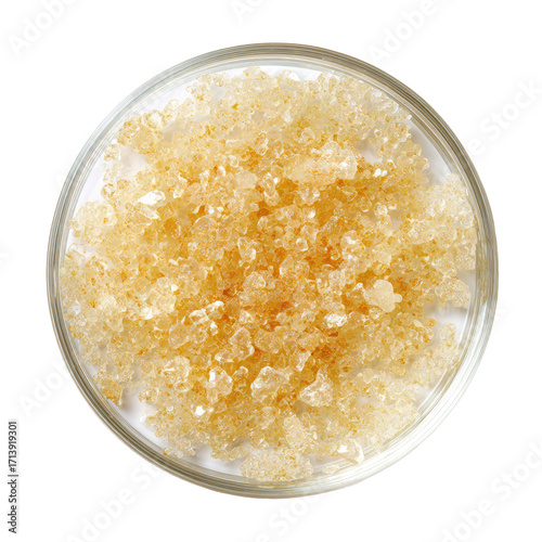 Small, light amber crystals in a petri dish