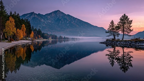 Mountain lake at dawn, autumn colors reflected