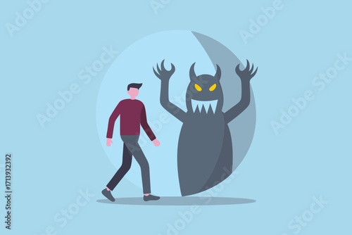 Man walking away from a scary monster shadow representing fear or anxiety