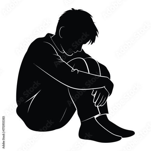 Silhouette of a person sitting curled up with head down expressing sadness and loneliness