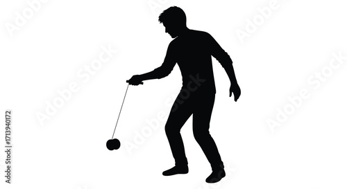 Silhouette of a man skillfully playing with a classic yo yo toy