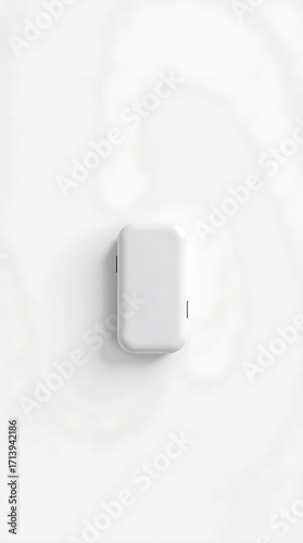 Minimalist white wall mounted dispenser with subtle shadows and clean lines