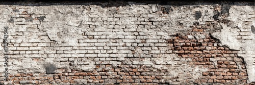 Weathered brick wall with sections of crumbling plaster