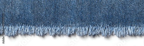 Close-up of a frayed denim edge against a white background; showing textured blue fabric and unevenly cut fibers