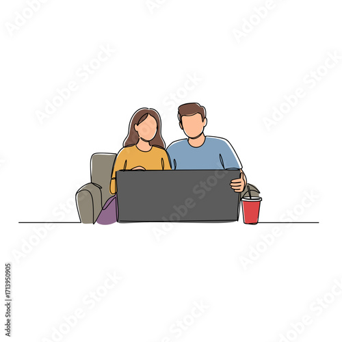 Young couple watching movie together on couch with laptop  