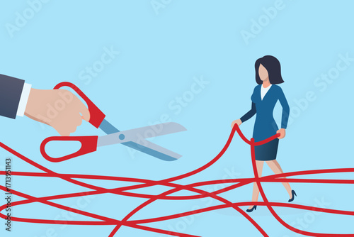 Businesswoman navigating tangled red tape while a hand with scissors prepares to cut through obstacles
