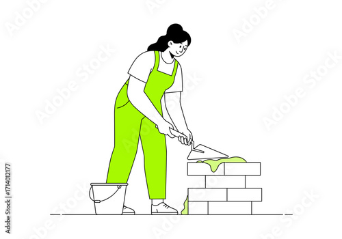 Woman constructing wall with trowel and bricks in bright overalls  
