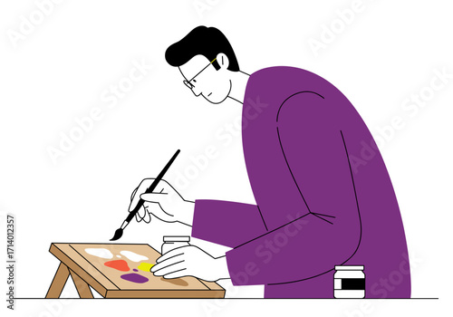 Man painting colorful patterns on canvas with brush in studio  