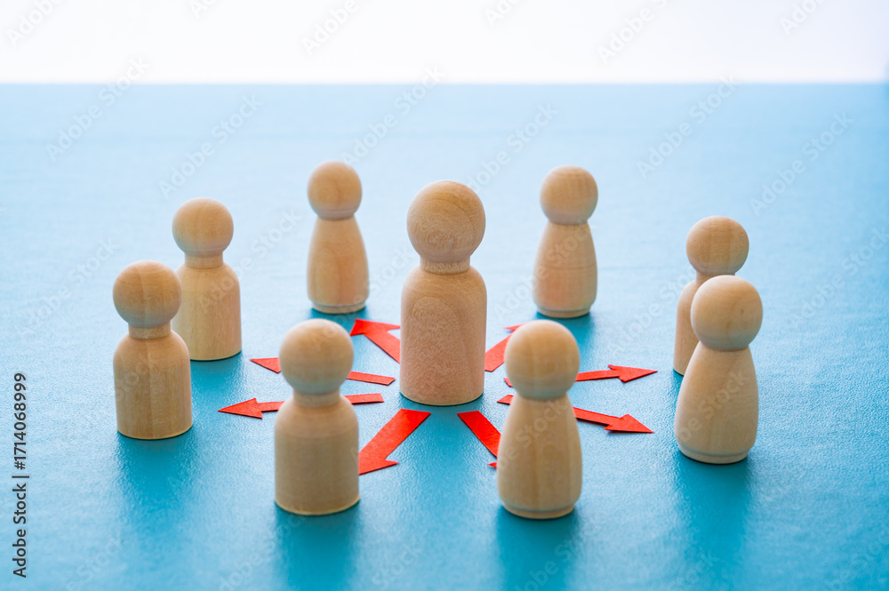 Obraz premium Concepts of communication, leadership, guidance, hierarchy, connection, expressed with a wooden figure and red arrows pointing to other figures.
