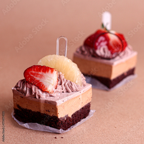 Bild auf Leinwand Chocolate layered cake squares with cream filling topped with glossy chocolate decoration