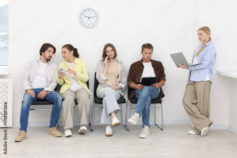 Fototapeta premium People waiting in queue on chairs indoors
