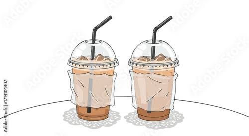 Two iced coffee drinks with straws and ice cubes, sitting on a table.