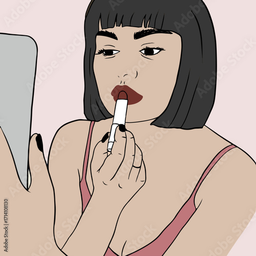 A stylish and confident woman with short black hair applies dark red lipstick.
