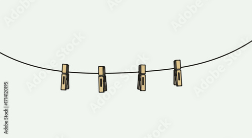 Clothesline with clothespins holding something. Clothesline with wooden clothespins on line. Clothesline suggests memories, drying, and simplicity, for vintage design, decoration, or home decor ideas.