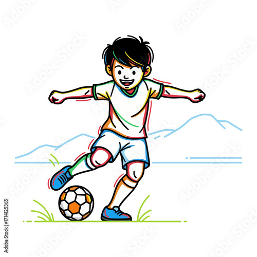 A young boy in a white soccer uniform kicks a soccer ball on a grassy field with mountains in the background.