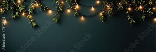 Elegant Green Leaf Garland with Glowing Lights Hanging on Dark Wall