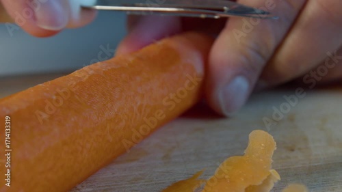 Mans hands peeling and carrot
