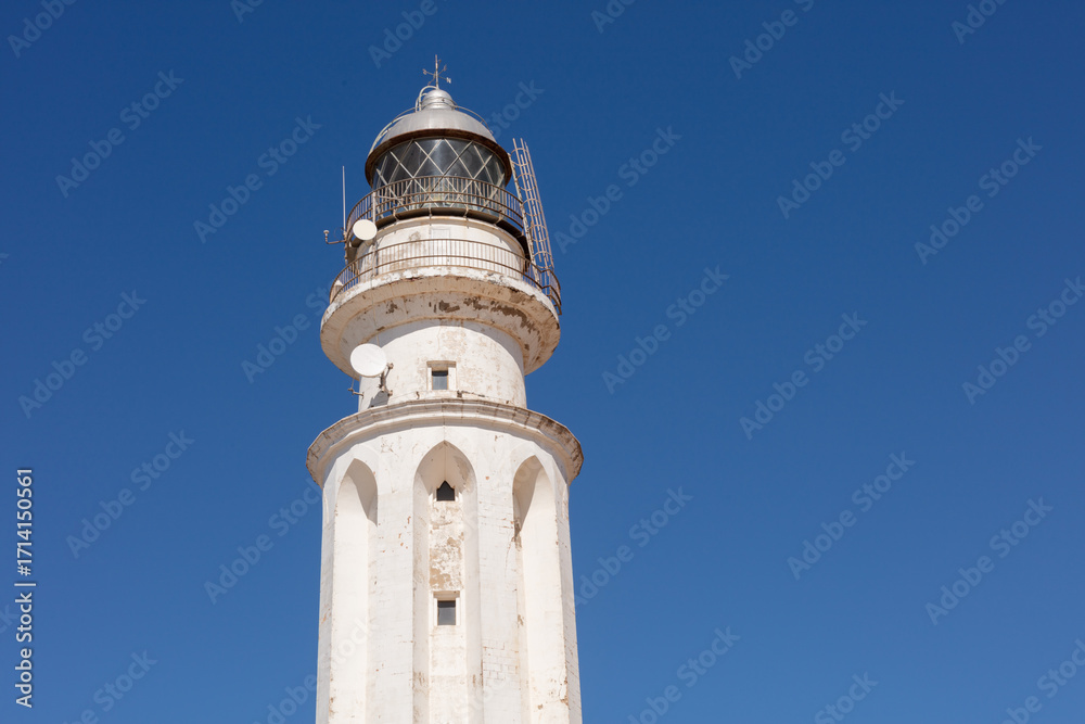 Fototapeta premium Los Canos de Meca, Tarifa, Andalusia, Spain. 1 September 2025. Lighthouse and coastal sand dunes