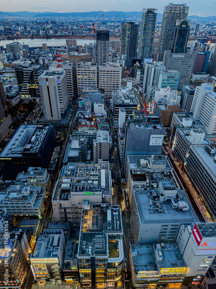 Fototapeta premium Osaka, Japan – January 12, 2025: Aerial view of modern city skyline with tall buildings